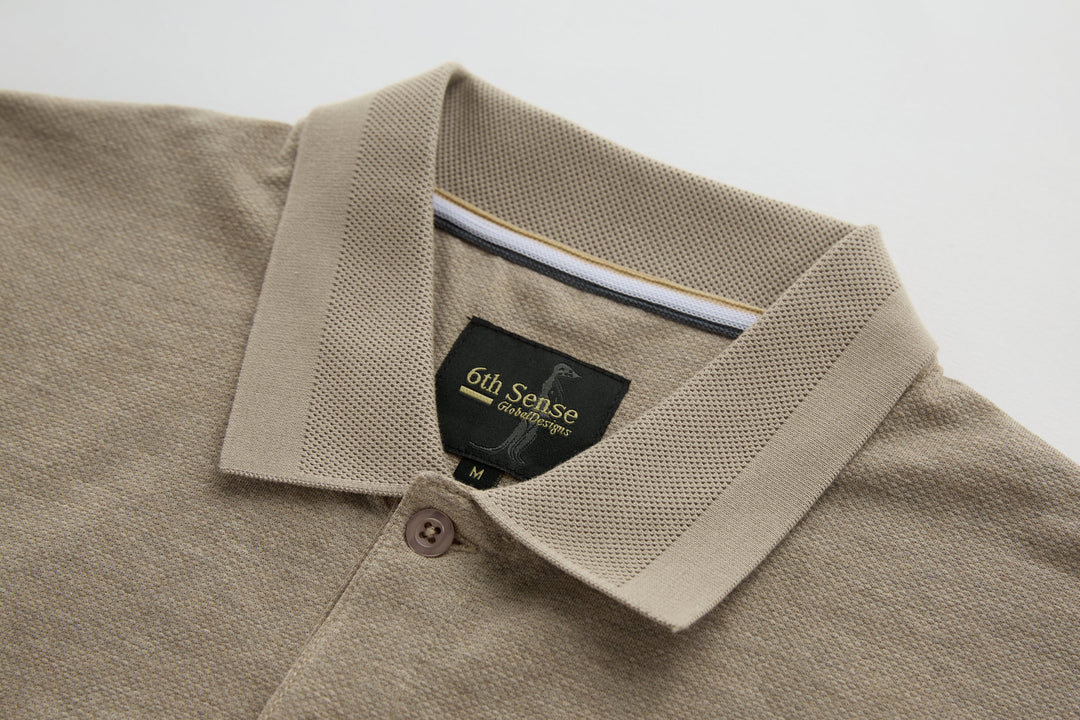 Beige long-sleeve polo shirt collar with button placket and brand label.