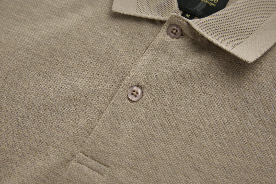 Beige long-sleeve polo shirt placket with two buttons and collar edge.