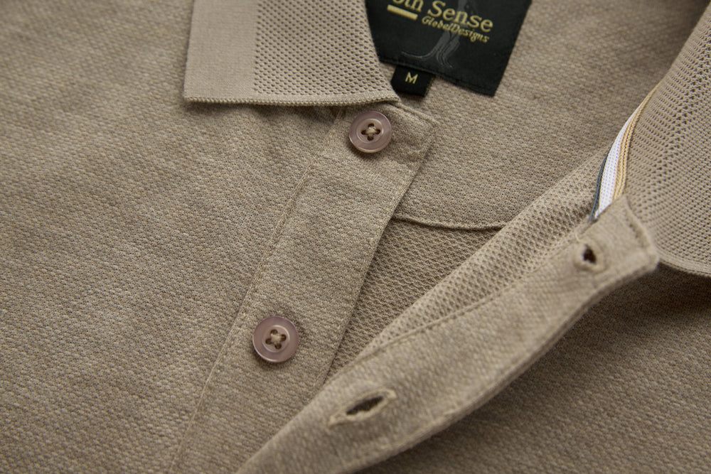Beige long-sleeve polo shirt with contrast inner collar trim and three-button placket.