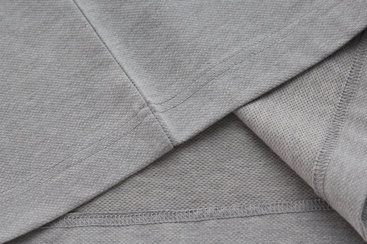 Long-sleeve polo shirt collar and neckline seam, light gray knit.