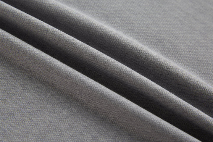Long-sleeve polo shirt texture close-up, light gray knit.