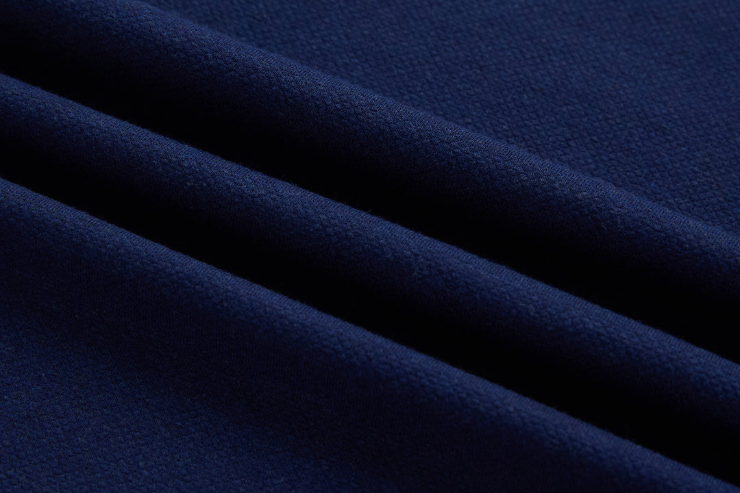 Dress blue polo shirt fabric close-up with fine knit texture, no visible buttons
