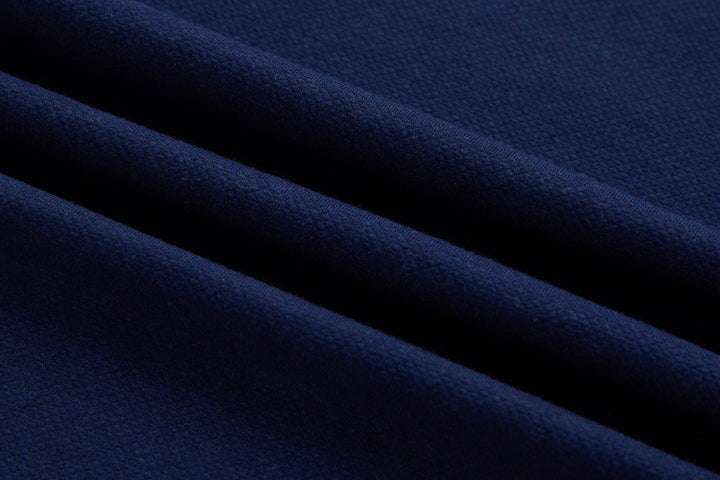 Dress blue polo shirt fabric close-up with fine knit texture, no visible buttons