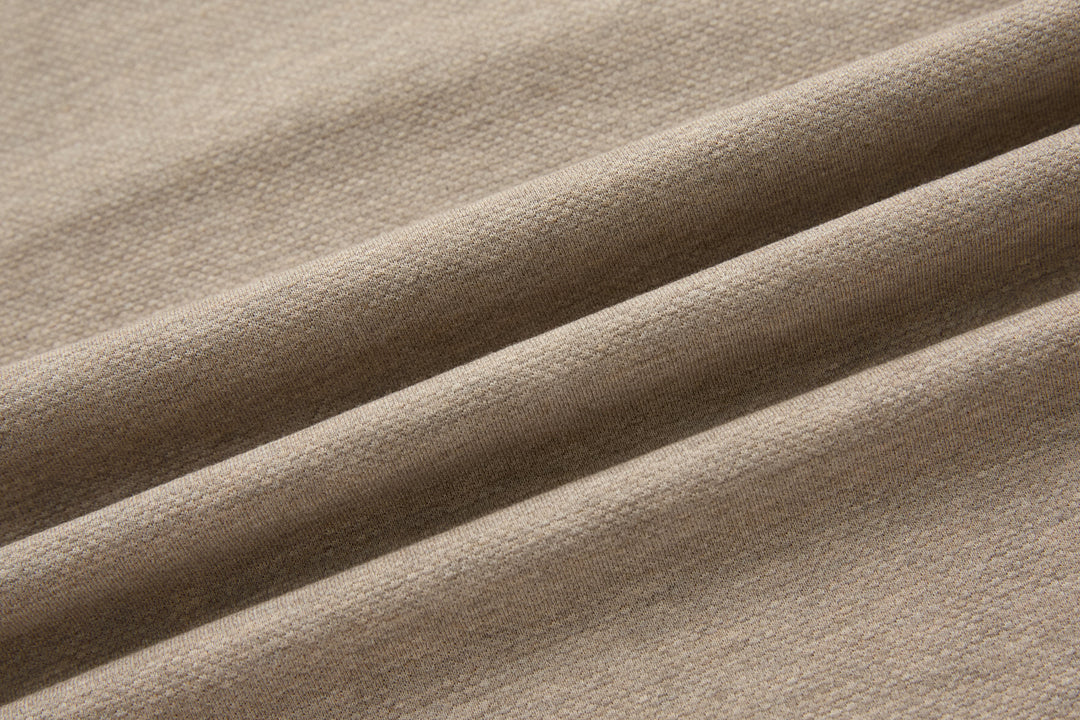 Beige polo shirt fabric texture with subtle seam and panel lines