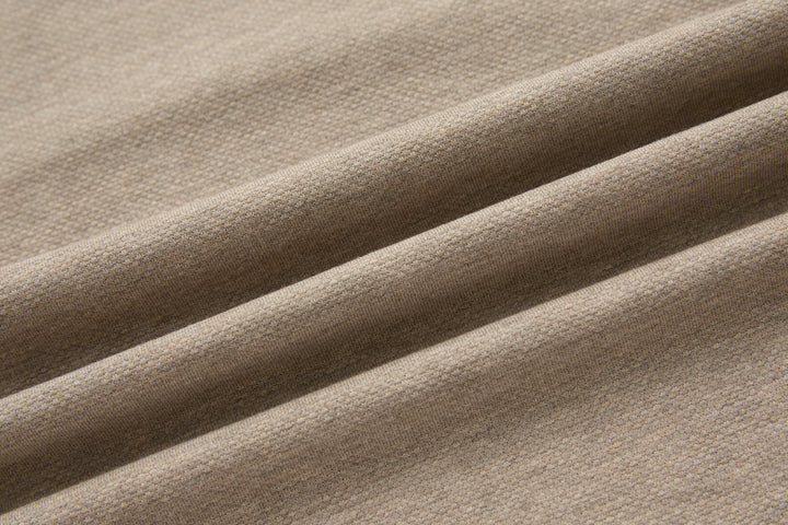 Beige polo shirt fabric texture with subtle seam and panel lines
