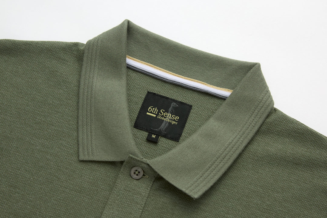 Olive polo shirt with fold-over collar and button placket, size tag visible
