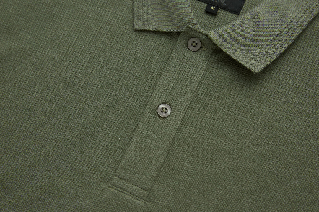 Olive polo shirt button placket and collar, two buttons close-up