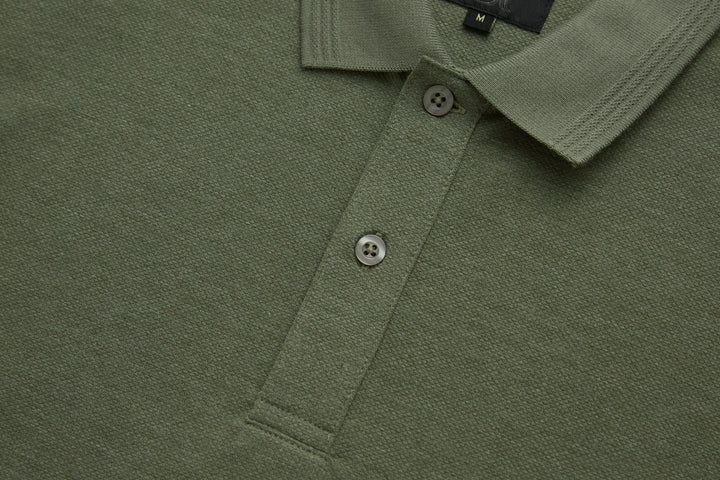 Olive polo shirt button placket and collar, two buttons close-up