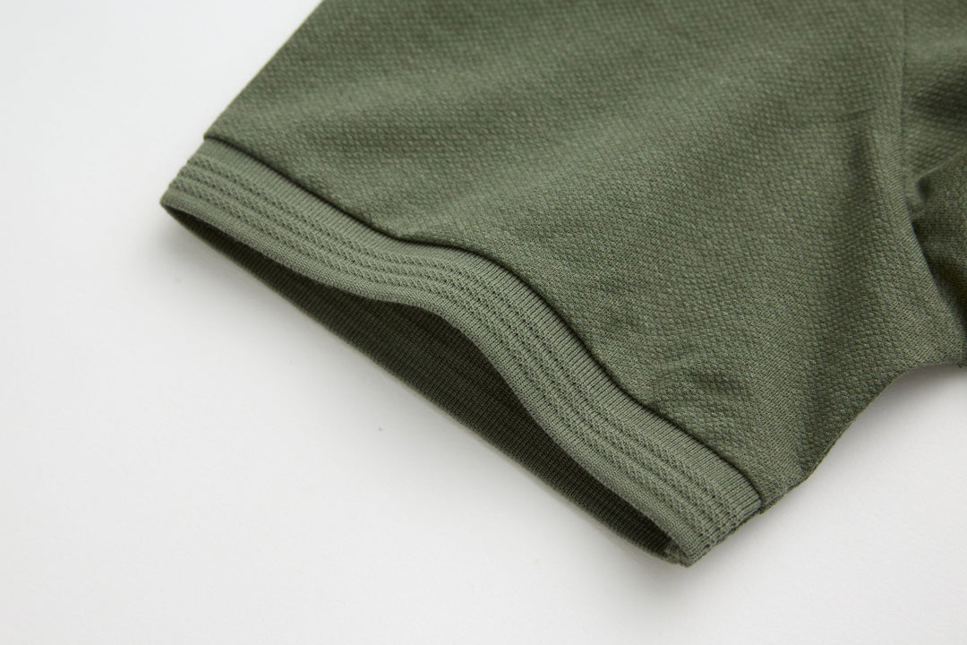 Olive polo shirt sleeve cuff with ribbed hem stitch detail
