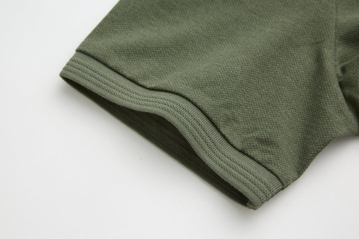Olive polo shirt sleeve cuff with ribbed hem stitch detail
