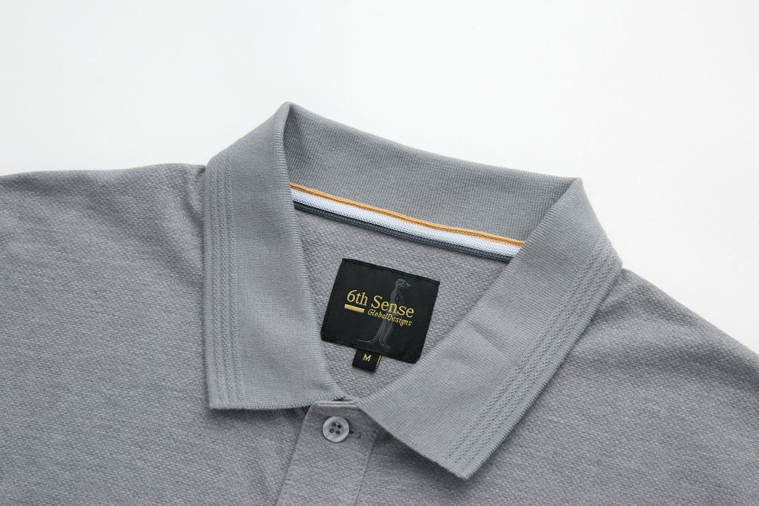Light gray polo shirt with folded collar and 6th Sense brand label