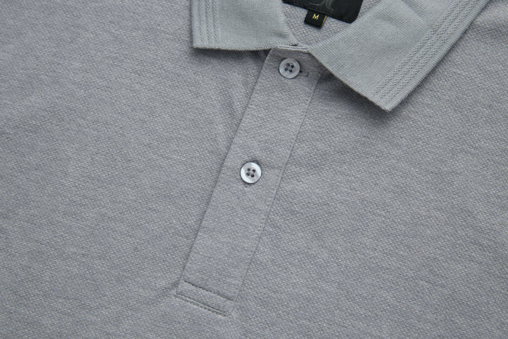Light gray polo shirt placket with white button closures