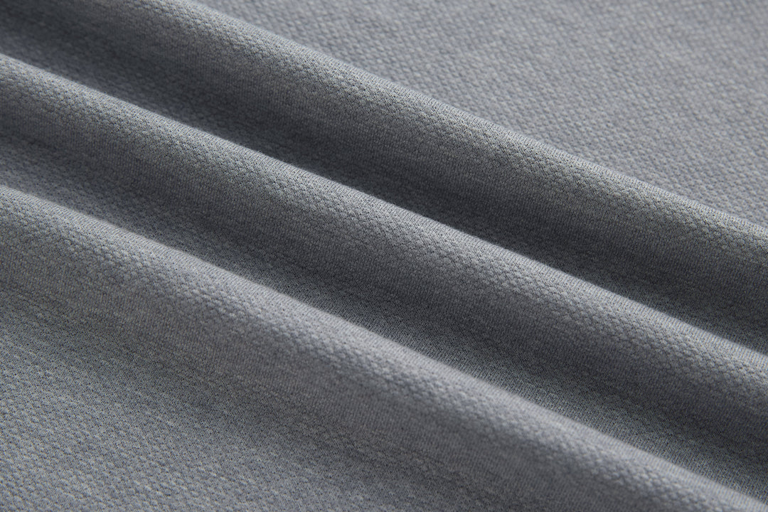Light gray polo shirt knit fabric close-up texture detail
