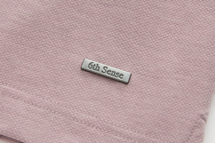 Woodrose polo shirt chest pocket and 6th Sense metal logo patch