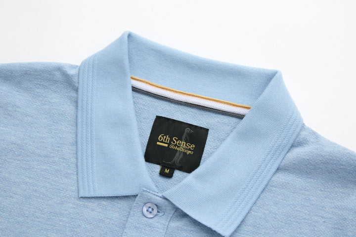 Sky blue polo shirt neckline with inner brand label and button