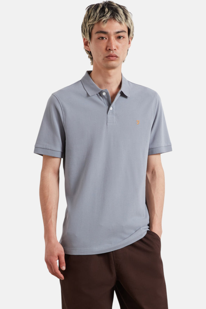 Light blue polo shirt, short sleeves, button placket, small chest logo.