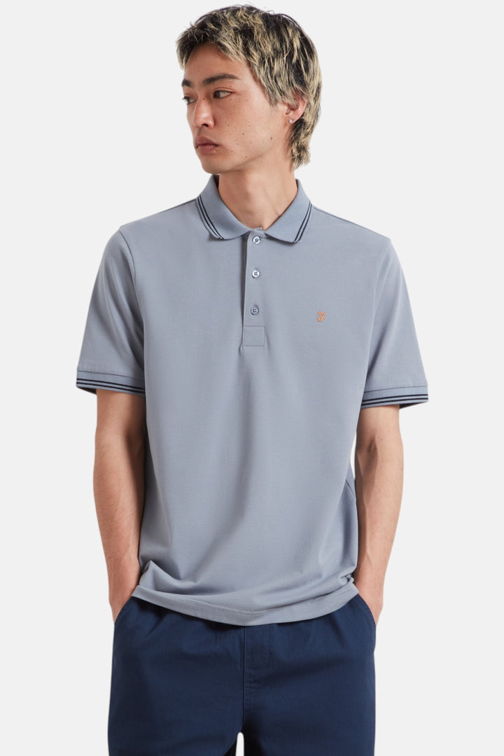 Men's light blue polo shirt with tipped collar and sleeve cuffs, button placket