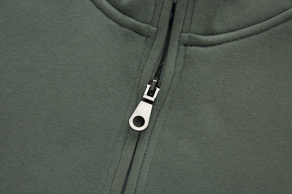 Olive 1/4-zip top zipper with metal pull and white zipper tab