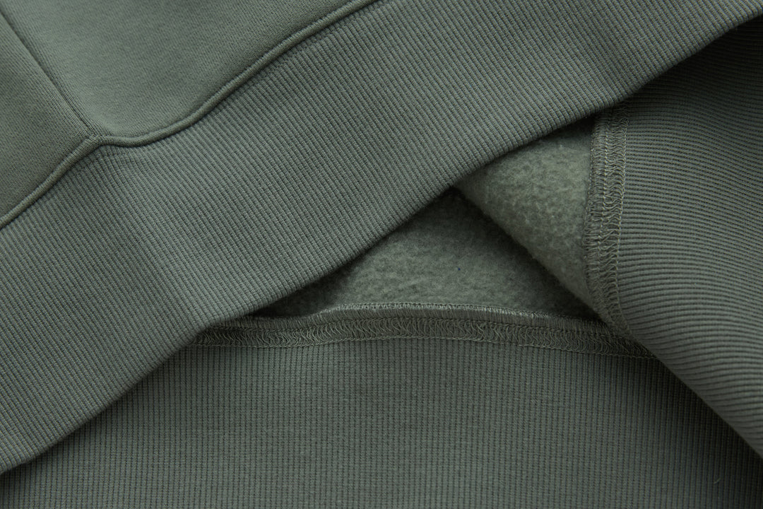 Olive 1/4-zip top, ribbed trim and inner seam detail