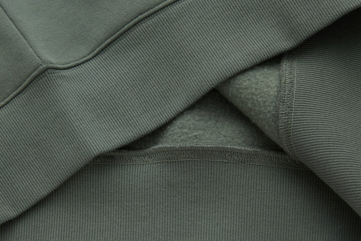 Olive 1/4-zip top, ribbed trim and inner seam detail