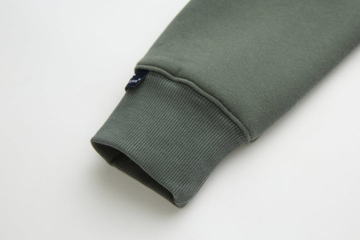 Olive 1/4-zip top sleeve cuff with ribbed knit hem