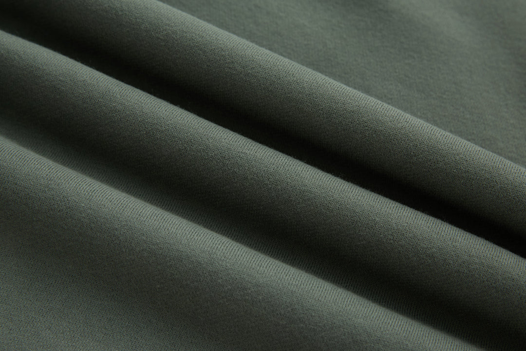 Olive 1/4-zip top, knit fabric close-up with smooth texture