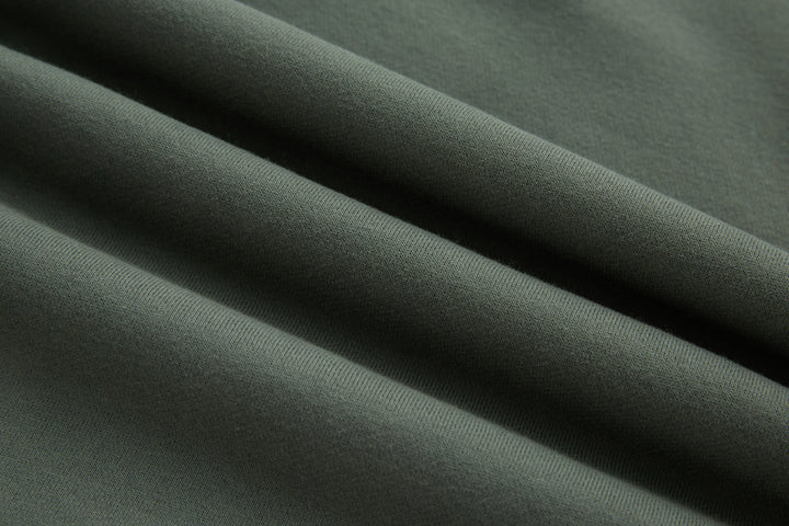 Olive 1/4-zip top, knit fabric close-up with smooth texture