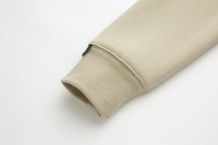 Beige 1/4-zip top sleeve cuff with ribbed hem
