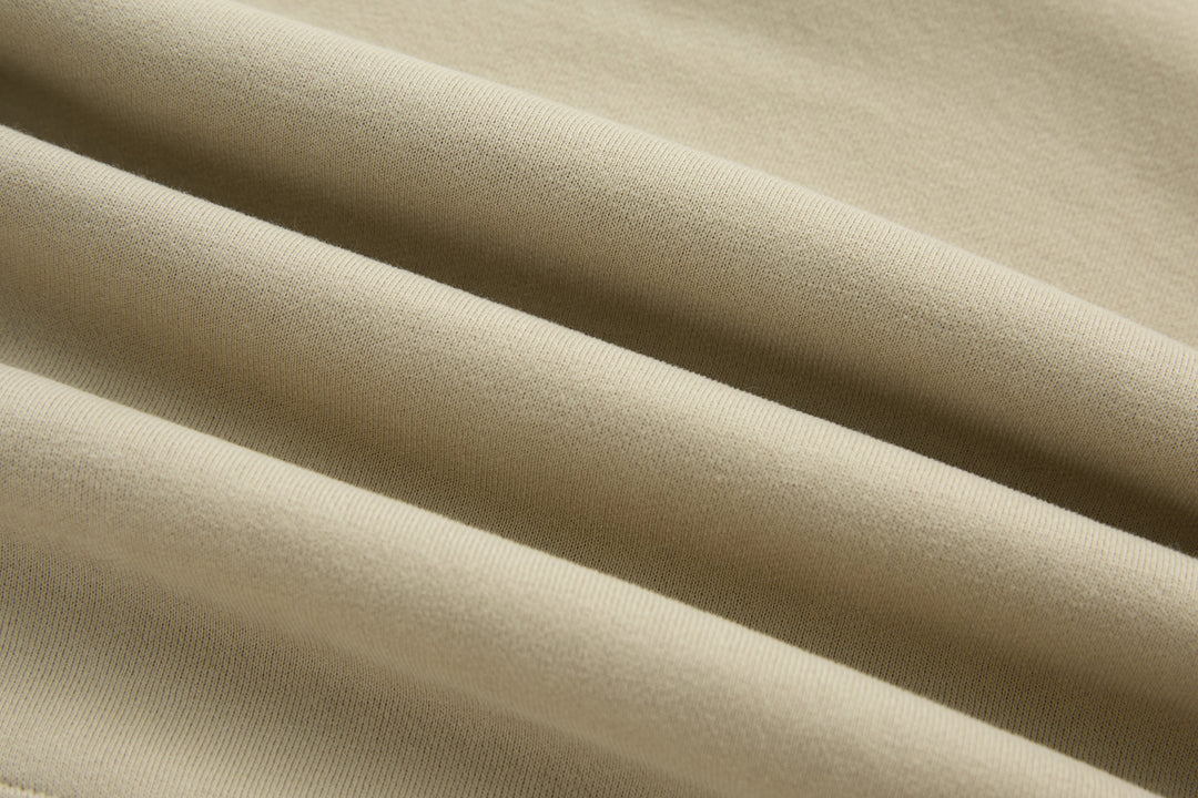 Beige knit fabric of 1/4-zip top with fine texture