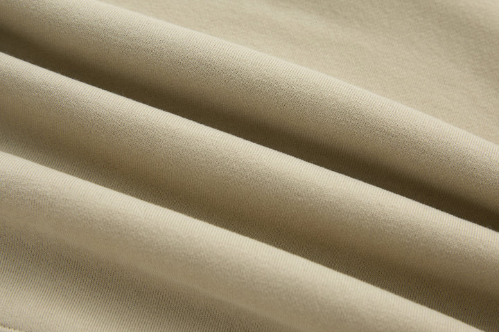 Beige knit fabric of 1/4-zip top with fine texture