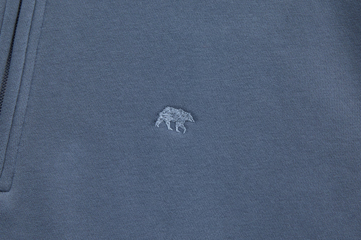 Blue 1/4-zip top with small chest logo embroidery