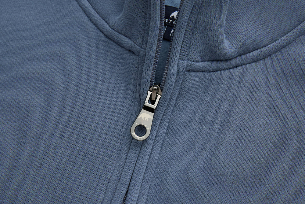 Blue 1/4-zip top metal zipper pull and placket