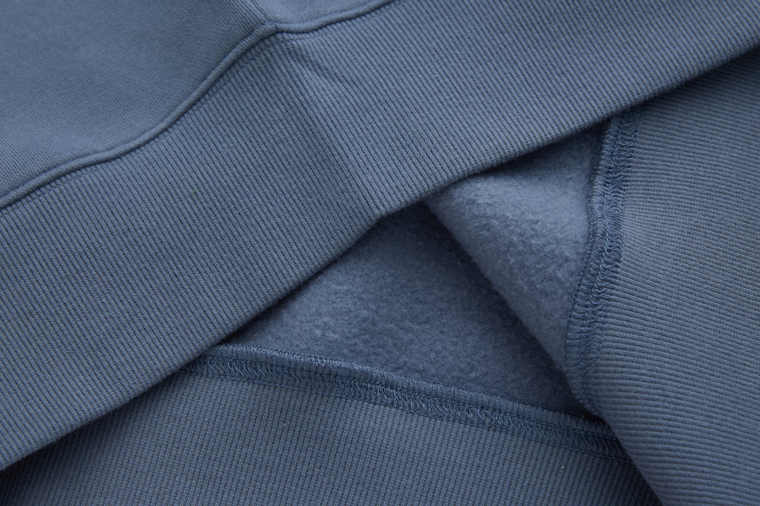 Blue 1/4-zip top sleeve ribbed cuff and seam detail
