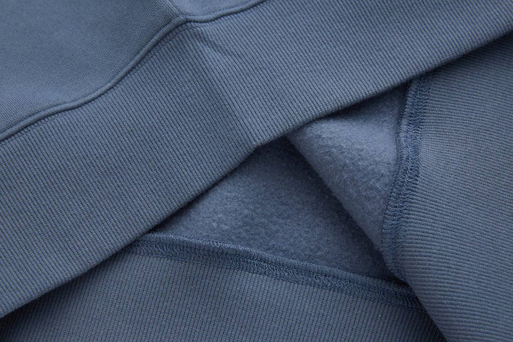 Blue 1/4-zip top sleeve ribbed cuff and seam detail