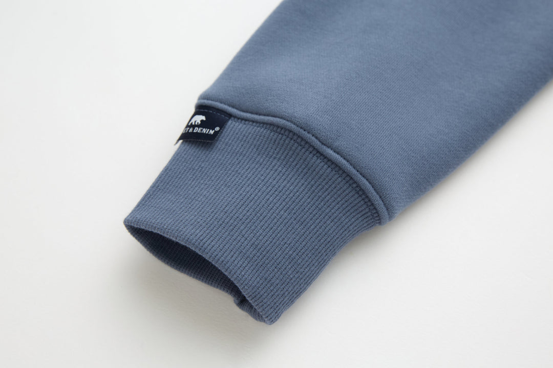Blue 1/4-zip top ribbed cuff with interior label