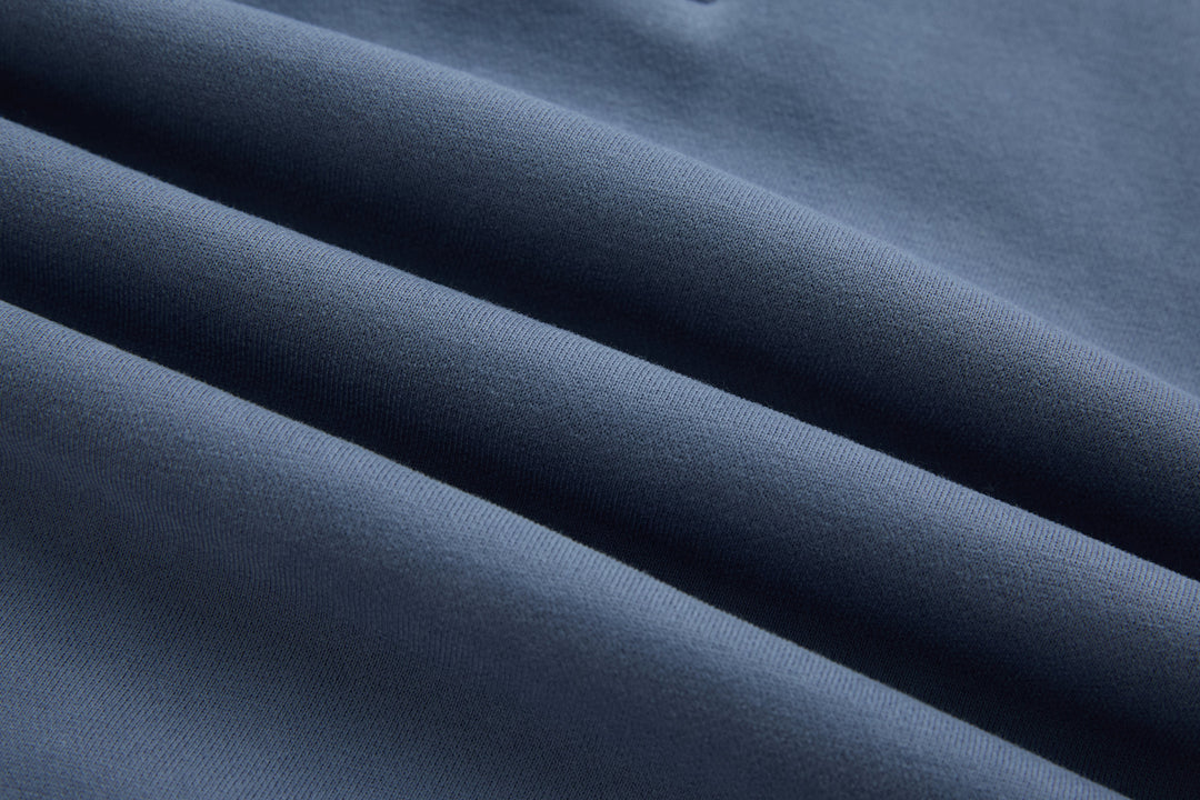 Blue knit 1/4-zip top fabric texture close-up