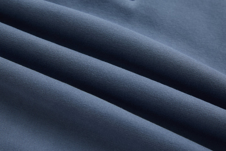 Blue knit 1/4-zip top fabric texture close-up