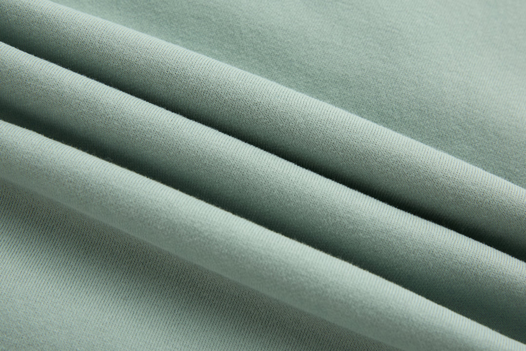 Jade 1/4-zip top fabric close-up with smooth knit texture