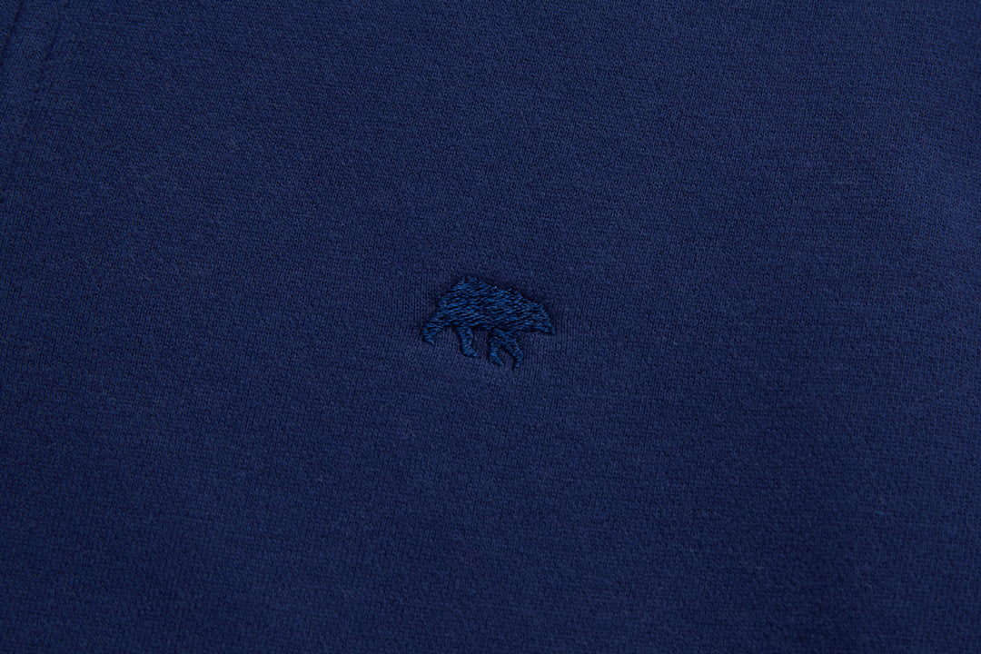 Dark blue top with small embroidered chest logo