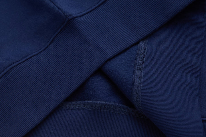 Dark blue top with layered placket and ribbed trim at neckline