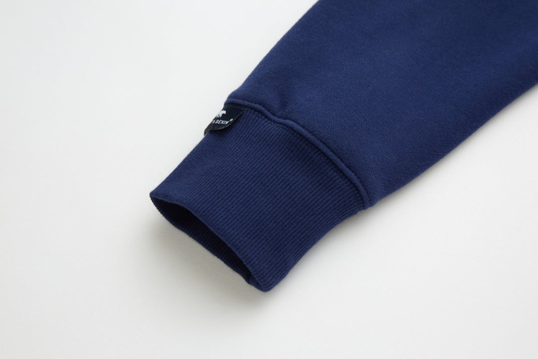 Dark blue 1/4-zip top sleeve cuff with ribbed knit hem