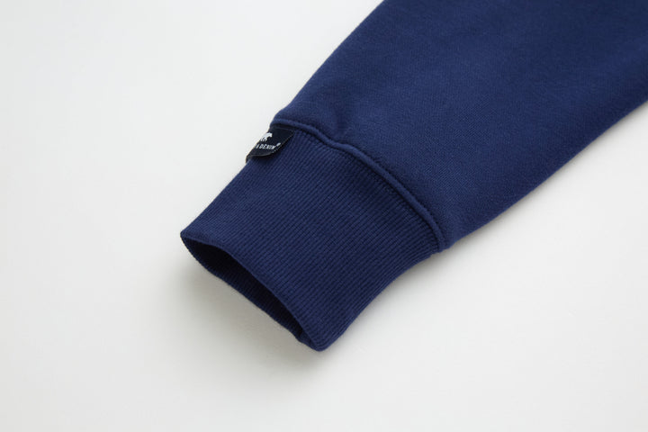 Dark blue 1/4-zip top sleeve cuff with ribbed knit hem