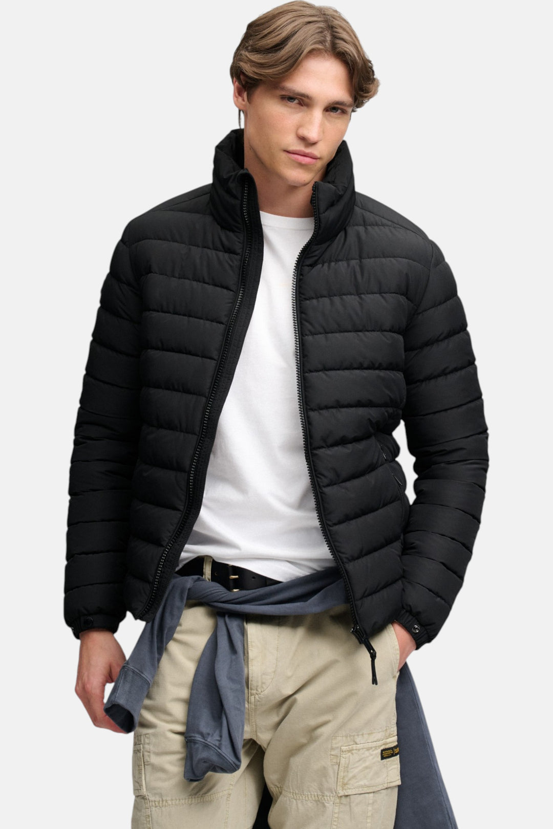 Black hooded puffer jacket with zip front and quilted padding, front three-quarter view
