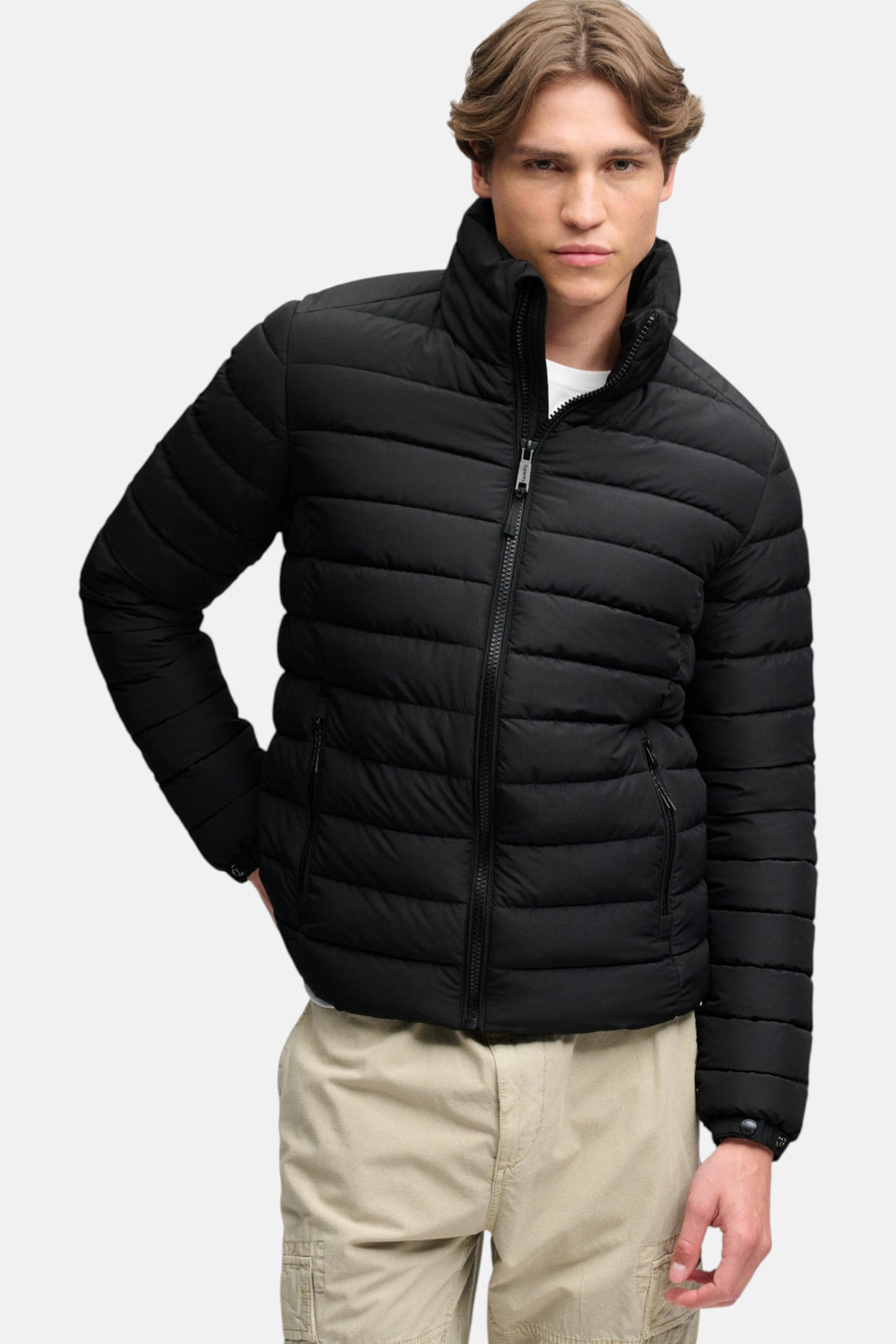 Black quilted hooded puffer jacket with zip front, ribbed cuffs and elastic hem