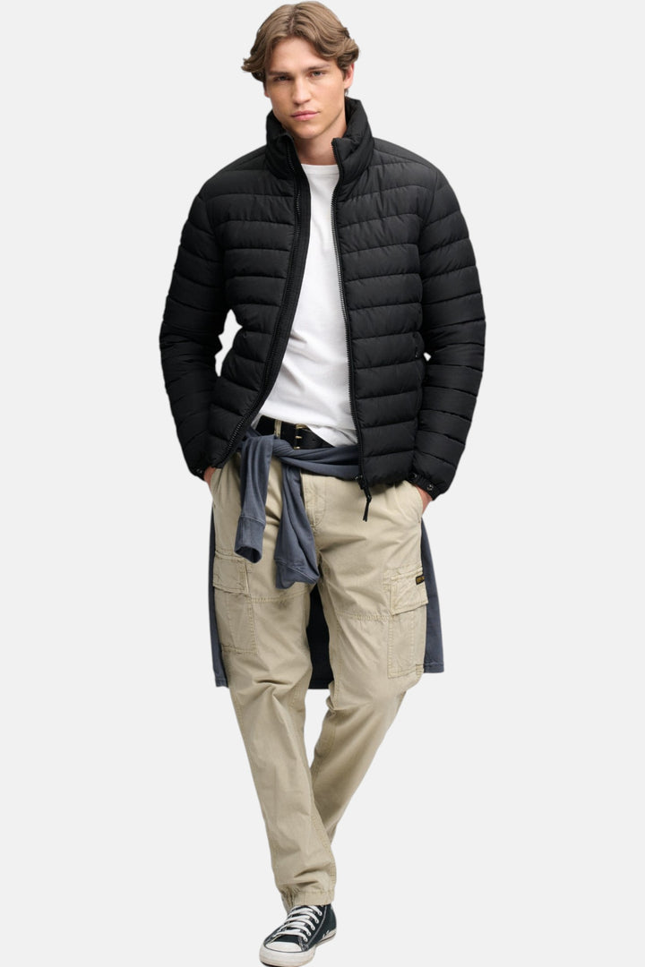 Black padded hooded puffer jacket with full-length front zipper, elastic cuffs