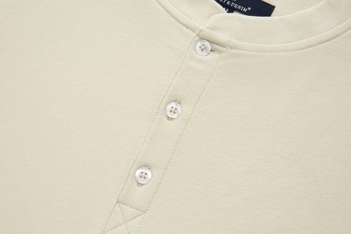 Bone denim top front with two white button fasteners, close-up