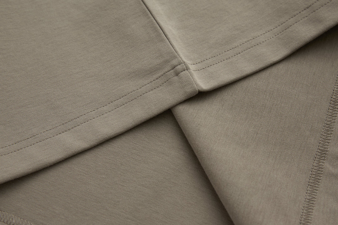Cinder grandad top hem and side seam with visible stitching