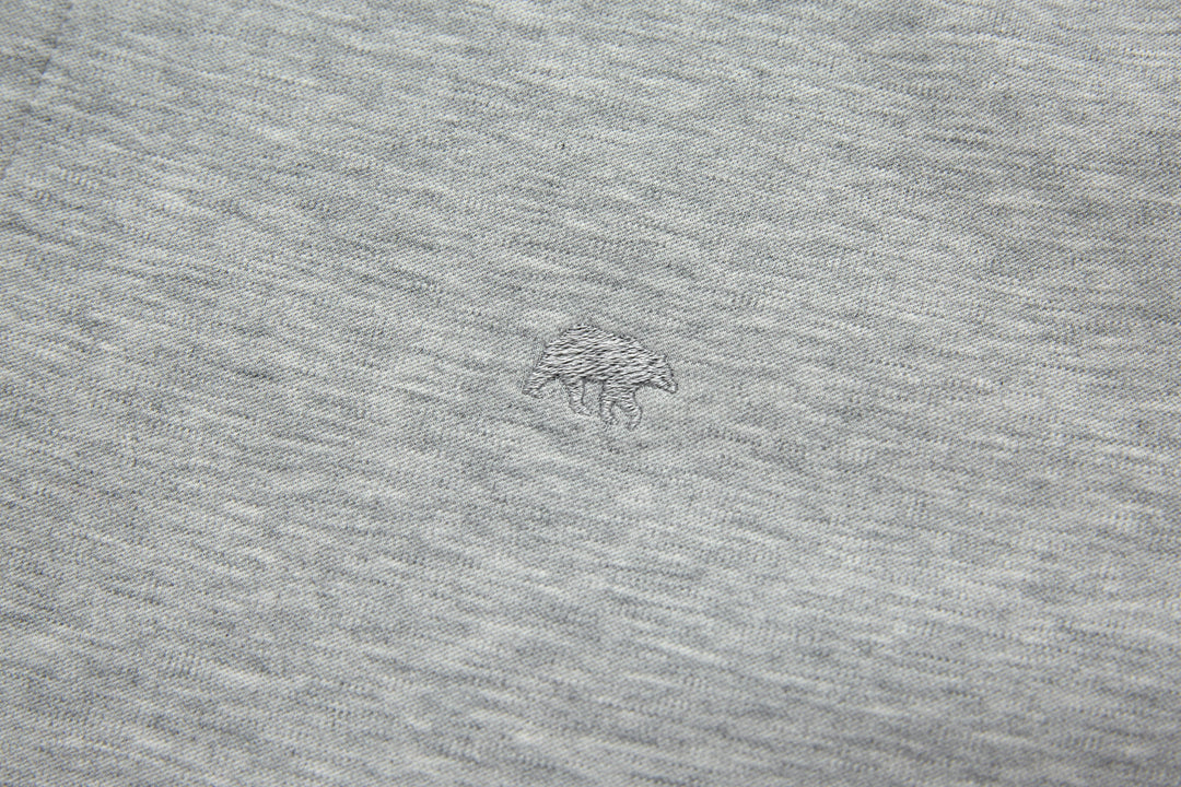Heather gray top fabric with small chest logo mark