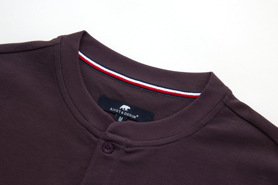 Raisin grandad-style top with curved neckline, button placket, branded neck label