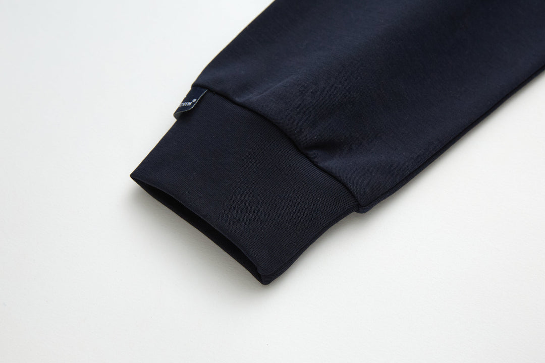 Navy top fabric close-up with visible stitching along side seam